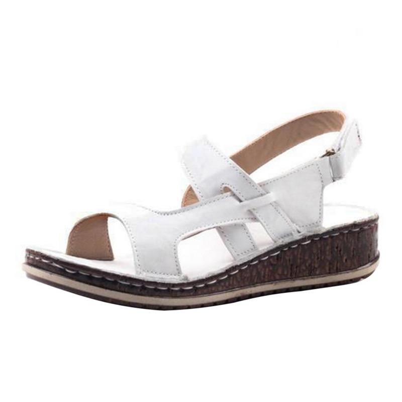 "Elegant women's strappy wedge sandals with open toes, slingback straps, and a cork-look base, perfect for summer style."