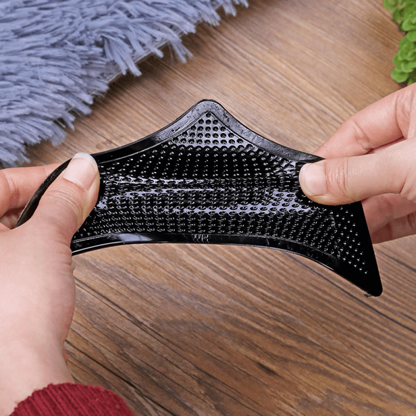 "Square non-slip rug gripper pads on light surface, self-adhesive and residue-free, ensuring rugs stay secure on all floors."