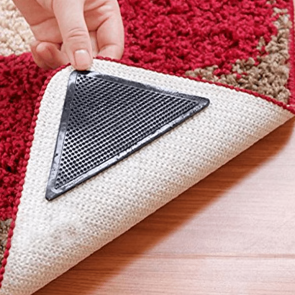 "Square non-slip rug gripper pads on light surface, self-adhesive and residue-free, ensuring rugs stay secure on all floors."