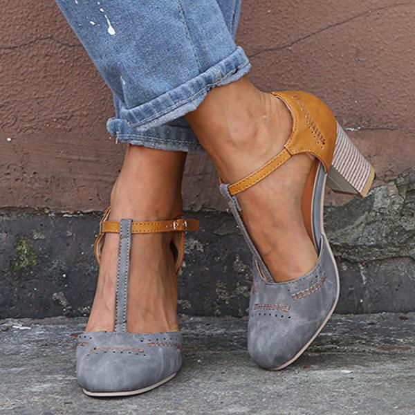 "T-Strap block heels with vintage charm, closed round toe, adjustable ankle buckle, faux suede finish."
