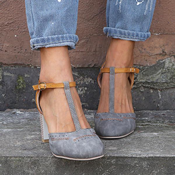"T-Strap block heels with vintage charm, closed round toe, adjustable ankle buckle, faux suede finish."
