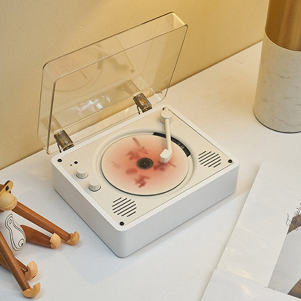 "Vintage-inspired CD player with chrome accents, analog knobs, and LCD display, blending nostalgic design with modern tech."