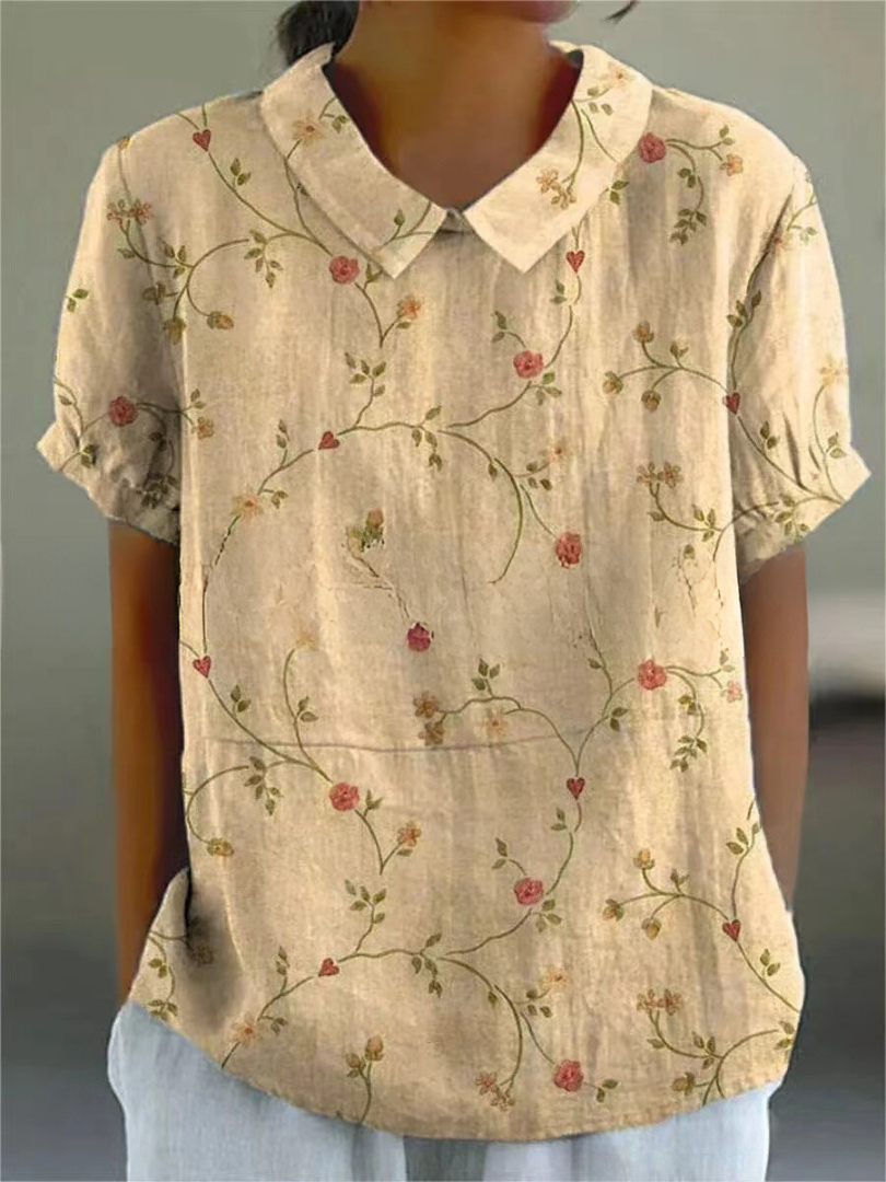 Women's blouse with short gathered sleeves, pointed collar, relaxed fit, perfect for spring-summer style and comfort.