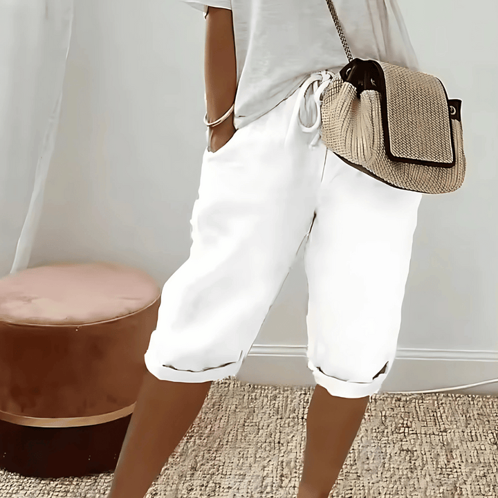 Comfortable high-rise women's harem shorts, knee-length with elastic waist, perfect for relaxing summer casual wear.