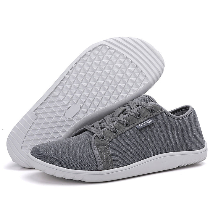 Person wearing lightweight unisex zero-drop walking shoes, ideal for daily wear, comfort, and natural alignment.