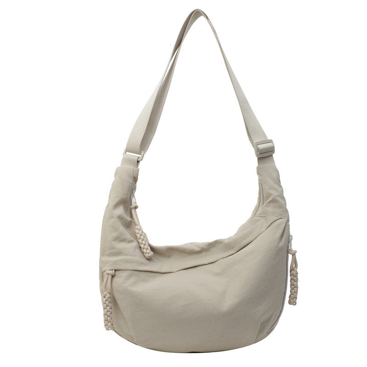 Lightweight nylon crescent travel bag for women, ideal as a secure crossbody purse for adventures.