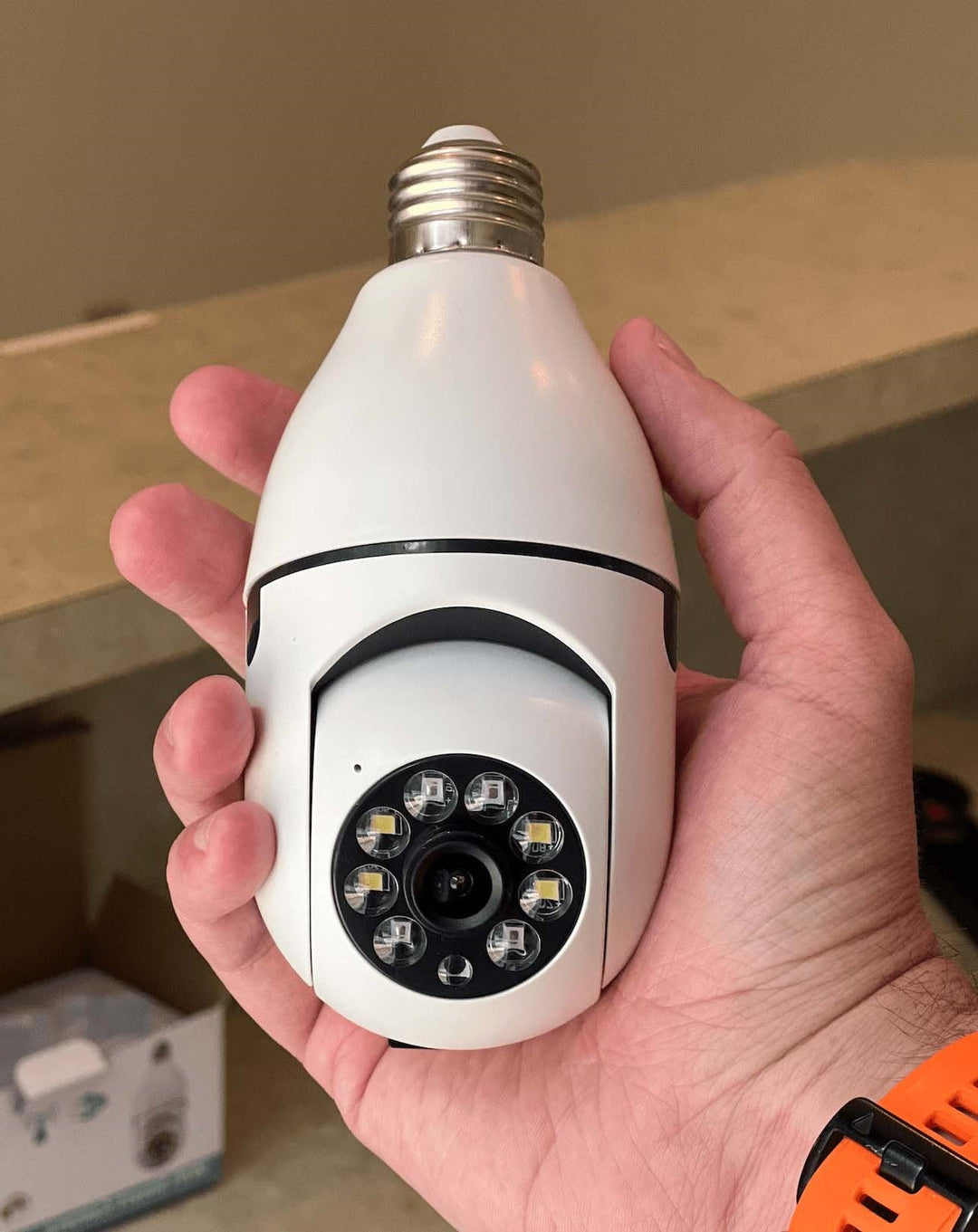 "360-degree light bulb security camera with night vision, installed in a socket, showing wireless panoramic home surveillance