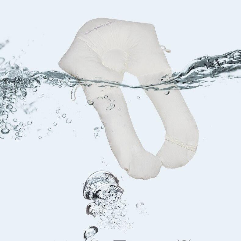 Organic cotton newborn head support pillow, U-shape, sleep aid for gentle infant comfort.