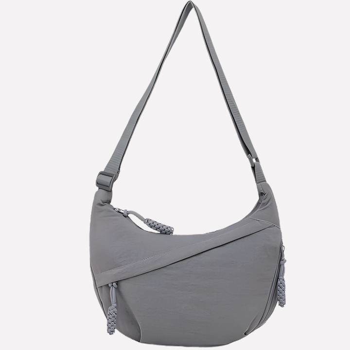 Woman wearing a nylon crescent crossbody bag, demonstrating comfortable, hands-free style.