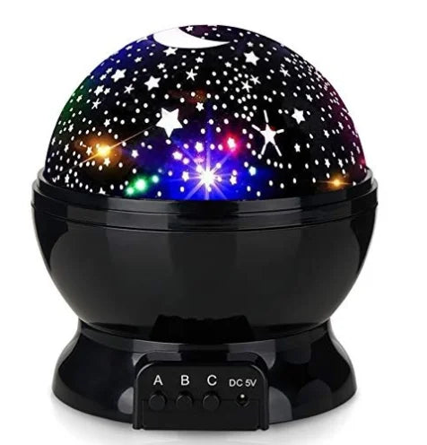 Children's LED star projector night light casting a magical starry sky on a bedroom ceiling for kids.