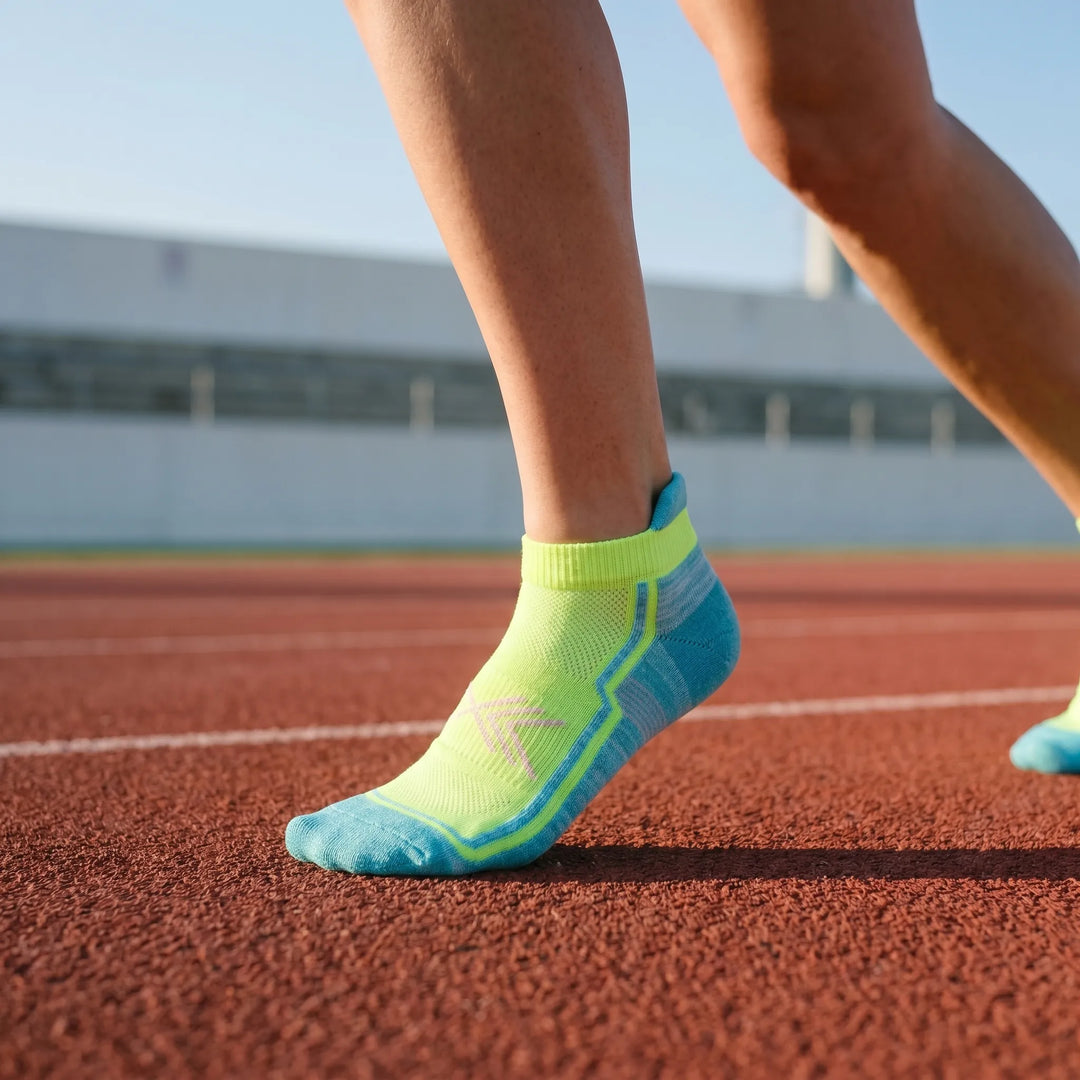 Women's green athletic ankle socks for activewear. Comfortable performance workout socks.
