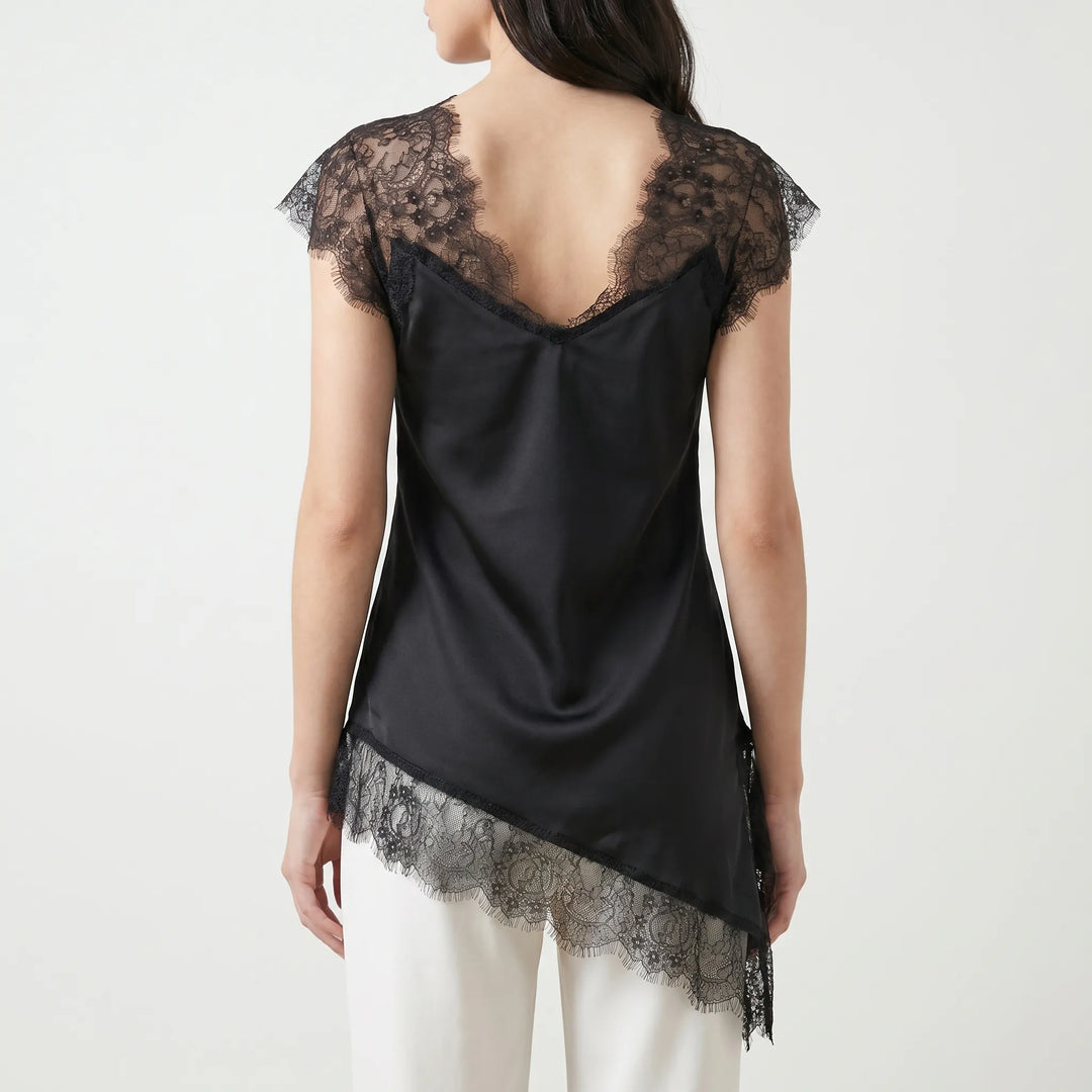 Fashionable women's asymmetrical blouse featuring sheer details & a stylish V-back. Chic summer party top.
