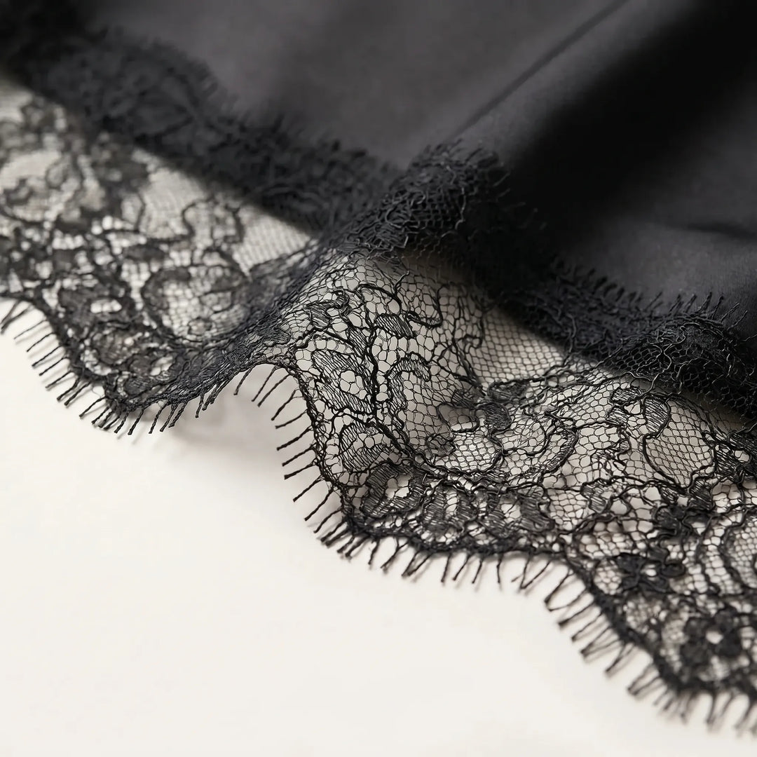 Elegant women's asymmetrical top with sheer fabric details, a versatile and fashionable evening blouse.