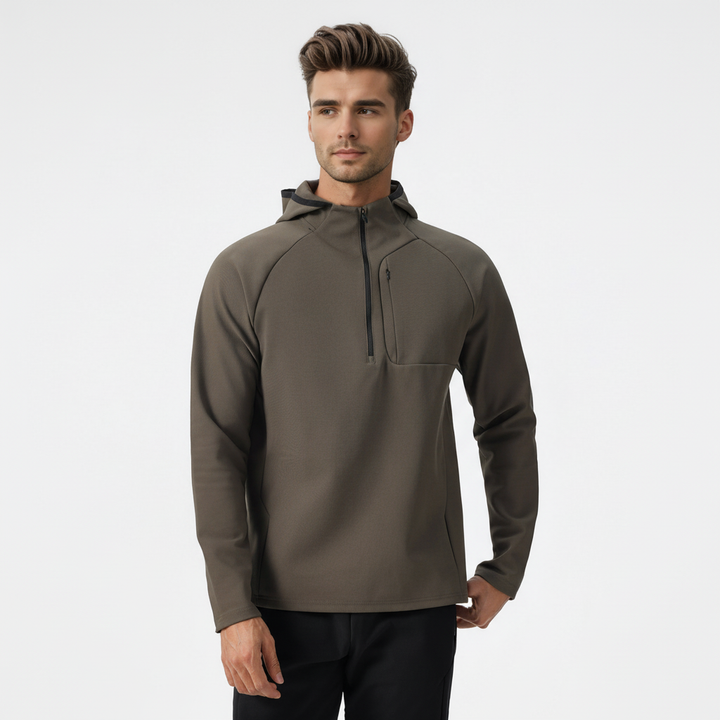 Guy wearing men's performance half-zip pullover. Flexible, breathable training top for active lifestyles.