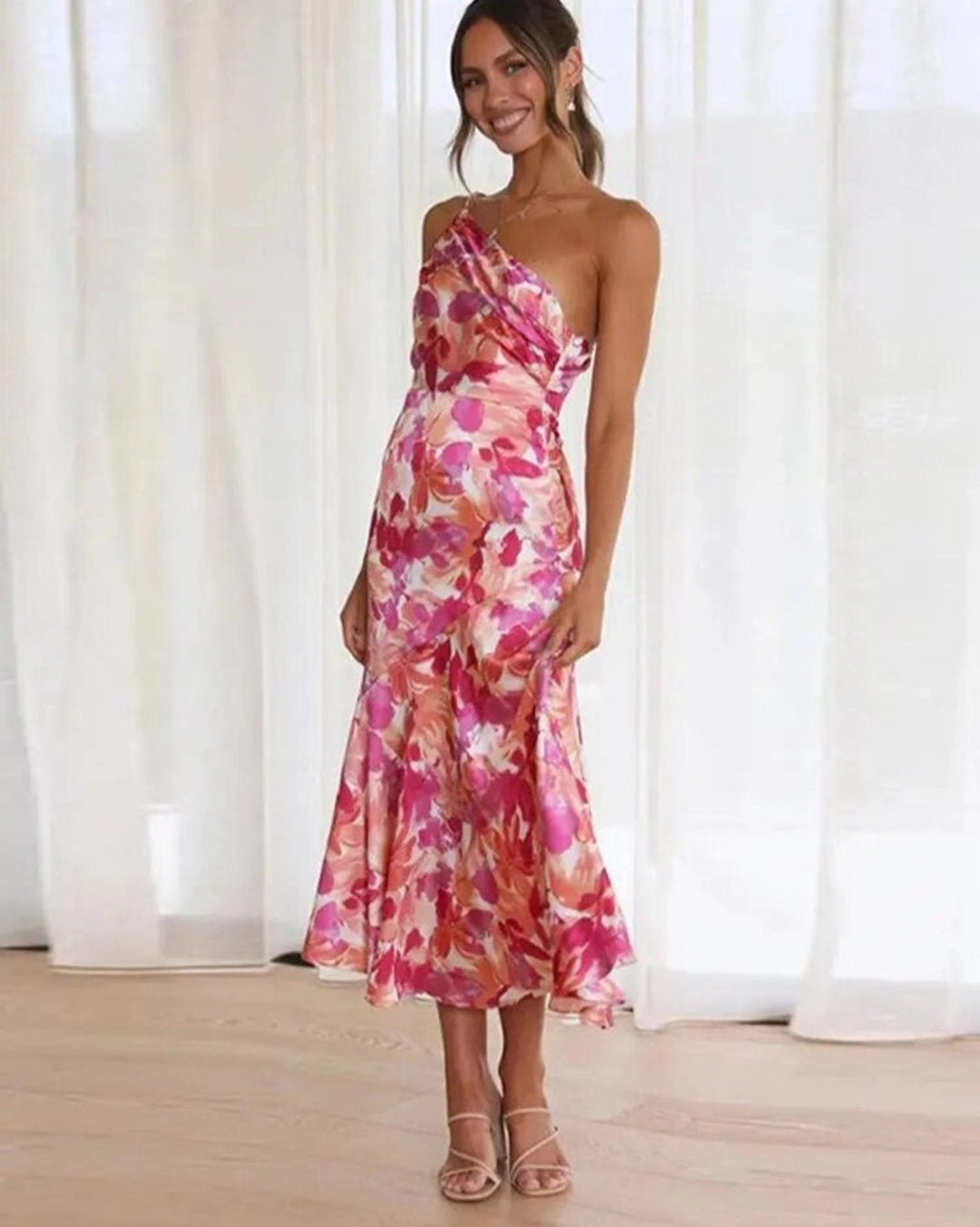 Elegant women's floral midi dress with an asymmetric hem, perfect for summer occasion wear.