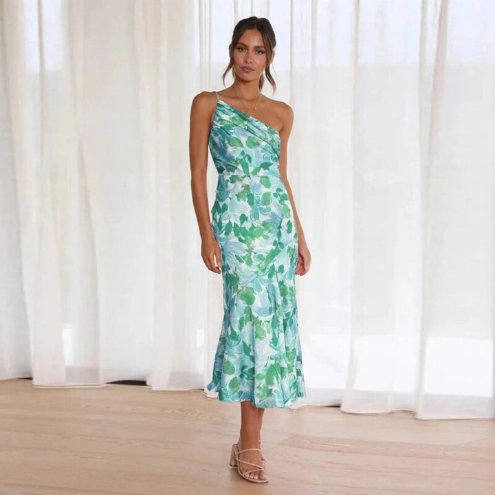 Flowing sleeveless floral midi dress for women, featuring a stylish asymmetric cut and vibrant print.