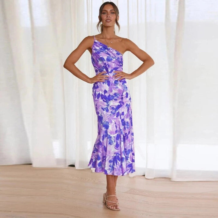 Stylish women's sleeveless floral midi dress with an elegant asymmetric hem. Ideal for summer.