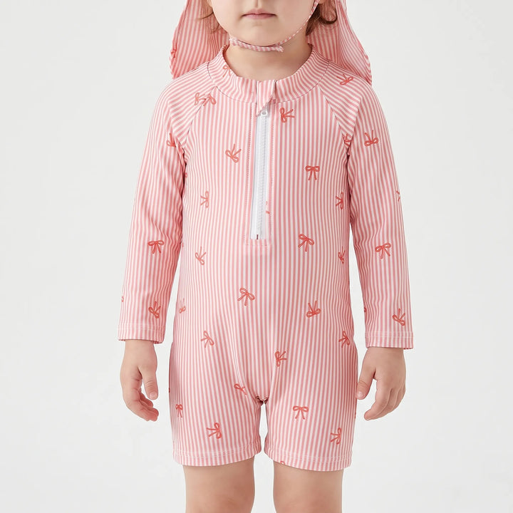 Long-sleeve girls' baby rash guard swimsuit, striped with bow print, designed for toddler and infant sun protection by the pool.