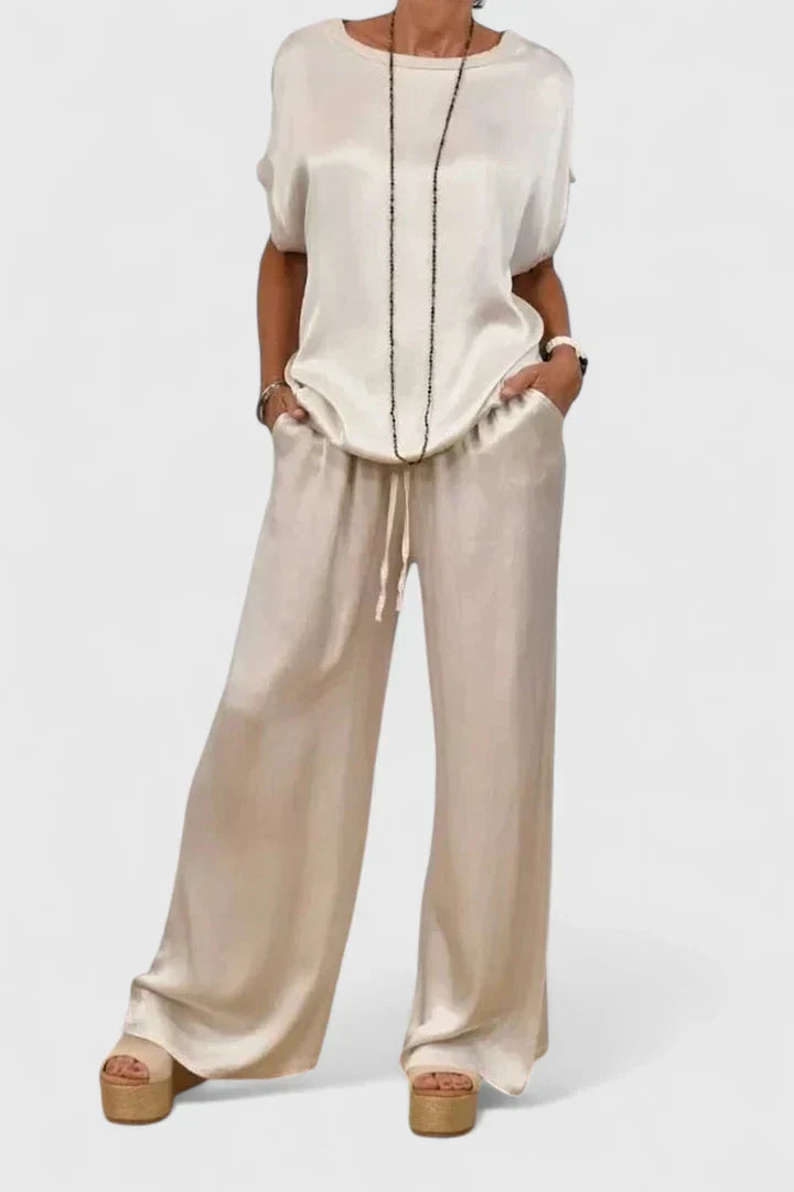 Sophisticated women's matching set: flowy batwing sleeve top and comfortable wide-leg trousers for an elegant smart casual look.