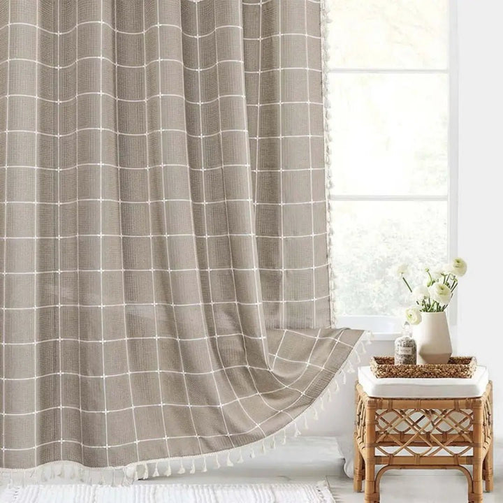 Full view of a waterproof Bohemian Farmhouse shower curtain with tassels, adding rustic elegance to any bathroom decor.
