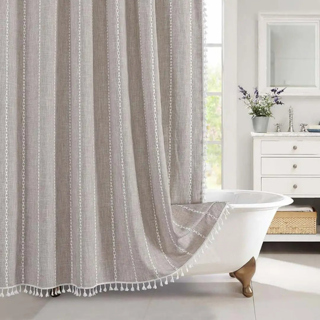 Detailed view of a striped Bohemian Farmhouse shower curtain with rustic texture and elegant tassels. Waterproof bathroom accent.