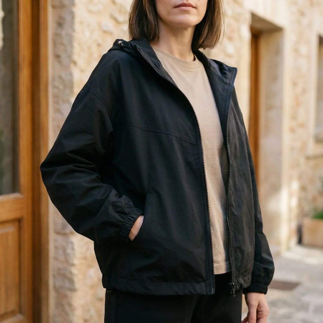 Women's lightweight hooded windbreaker jacket, perfect for spring/fall. Casual, weather-resistant outerwear with full zip.