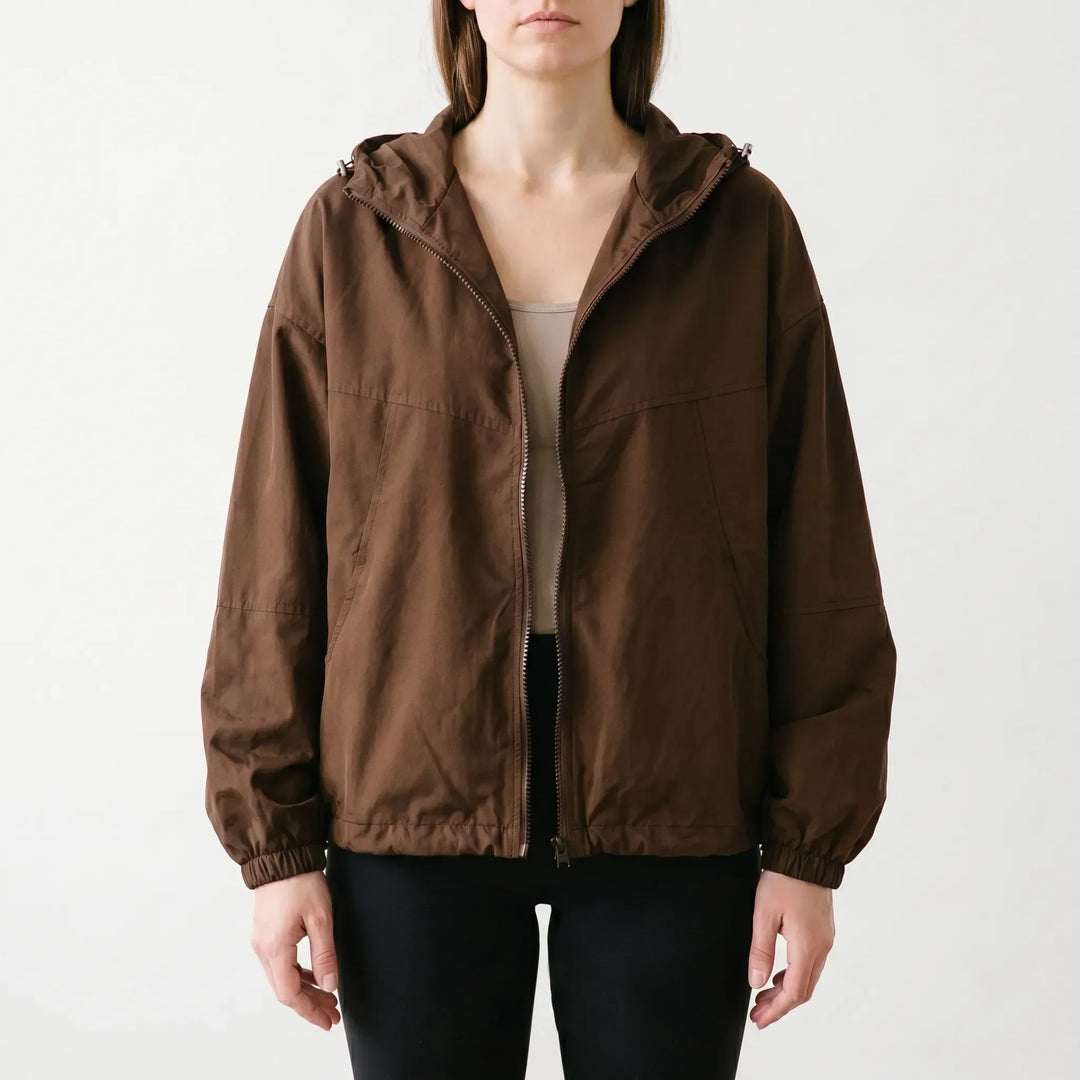 Women's lightweight hooded windbreaker jacket with full zip. Casual, weather-resistant outerwear for spring & fall comfort.