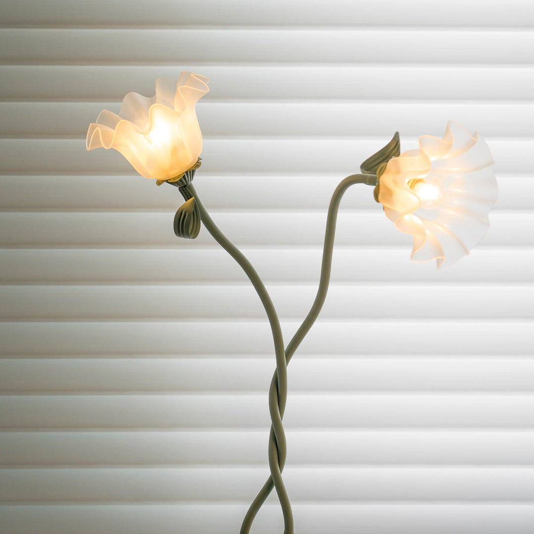 Modern green botanical floor lamp, elegant floral light for bedroom ambient decor.