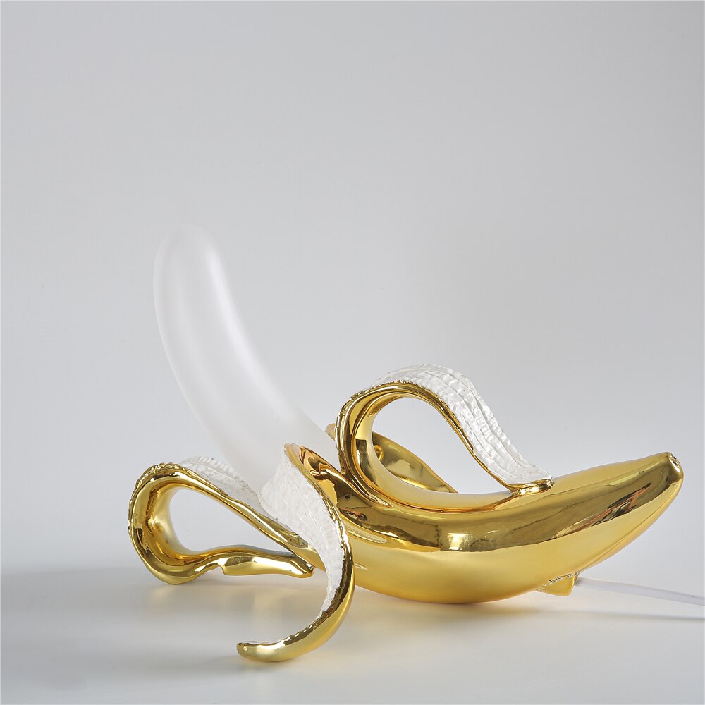 Decorative brass table lamp with chrome details, modern lighting fixture for any room.
