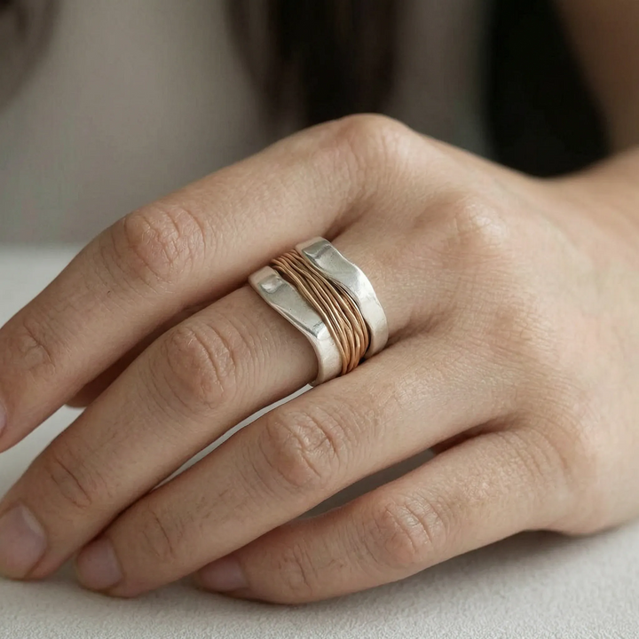 Elegant women's two-tone silver ring featuring a delicate gold wire accent. Modern fashion jewelry for everyday wear.