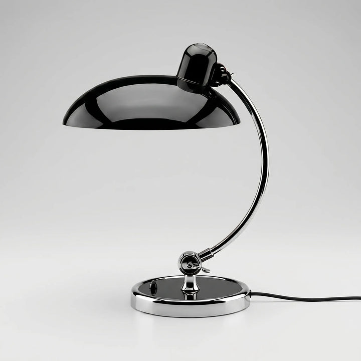 Stylish black metal dome desk lamp with an adjustable arm for targeted reading and task lighting.