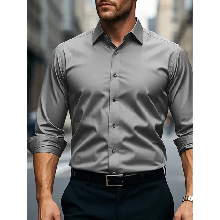 Tailored men's dress shirt with long sleeves and button-down collar, perfect for office or formal events.