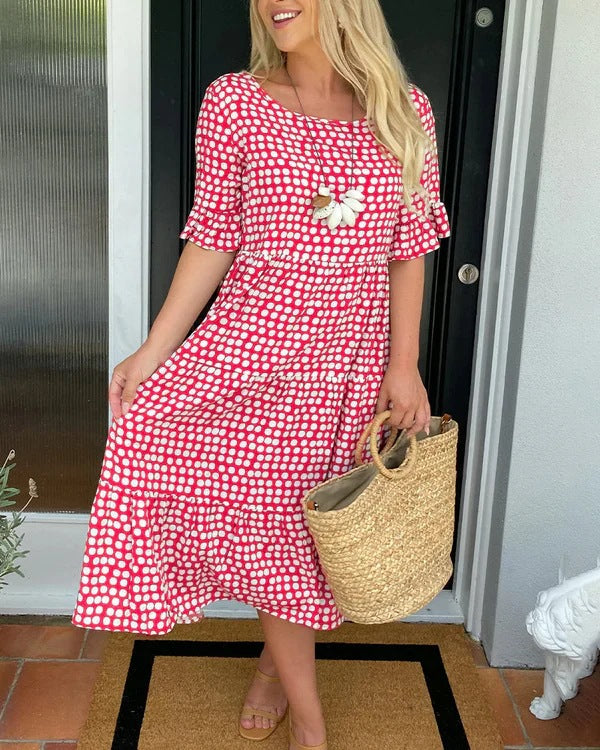 Women's black dotted midi dress with relaxed fit, perfect for casual summer outings and brunch. Flowy & comfortable.