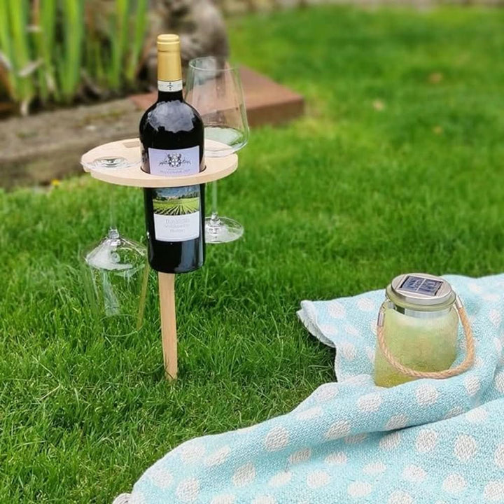 Elegant wooden portable wine table for outdoor dining. Easy to set up in garden, park, or beach for snacks & drinks.