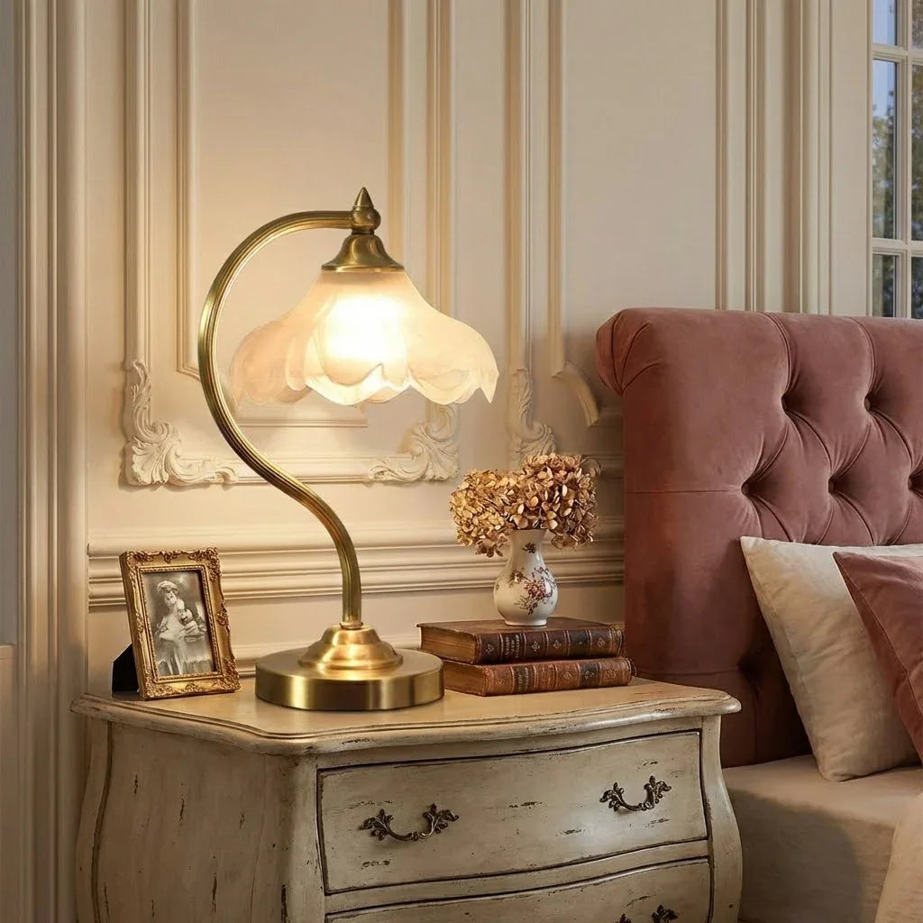 Modern brass accent lamp featuring a delicate floral pattern & dimmable functionality.