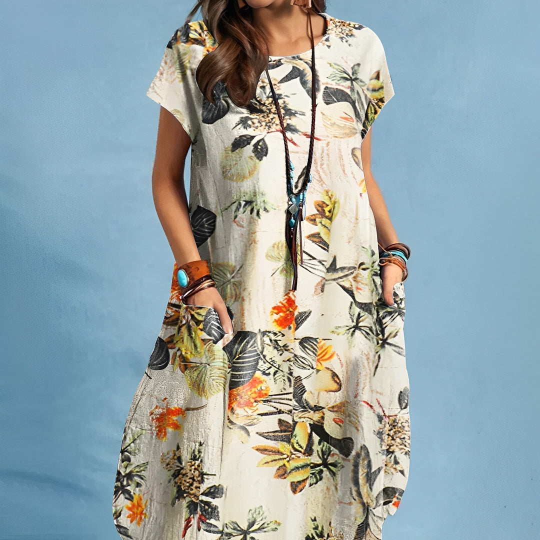 Flattering women's floral midi dress featuring short sleeves, round neck & practical pockets.