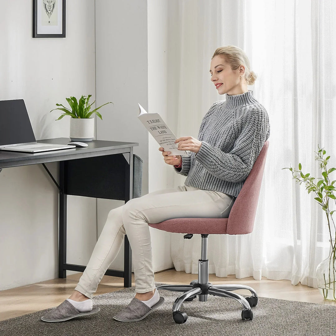 Unisex compact vanity chair with swivel base, ergonomic design & comfortable fabric for beauty & small offices.