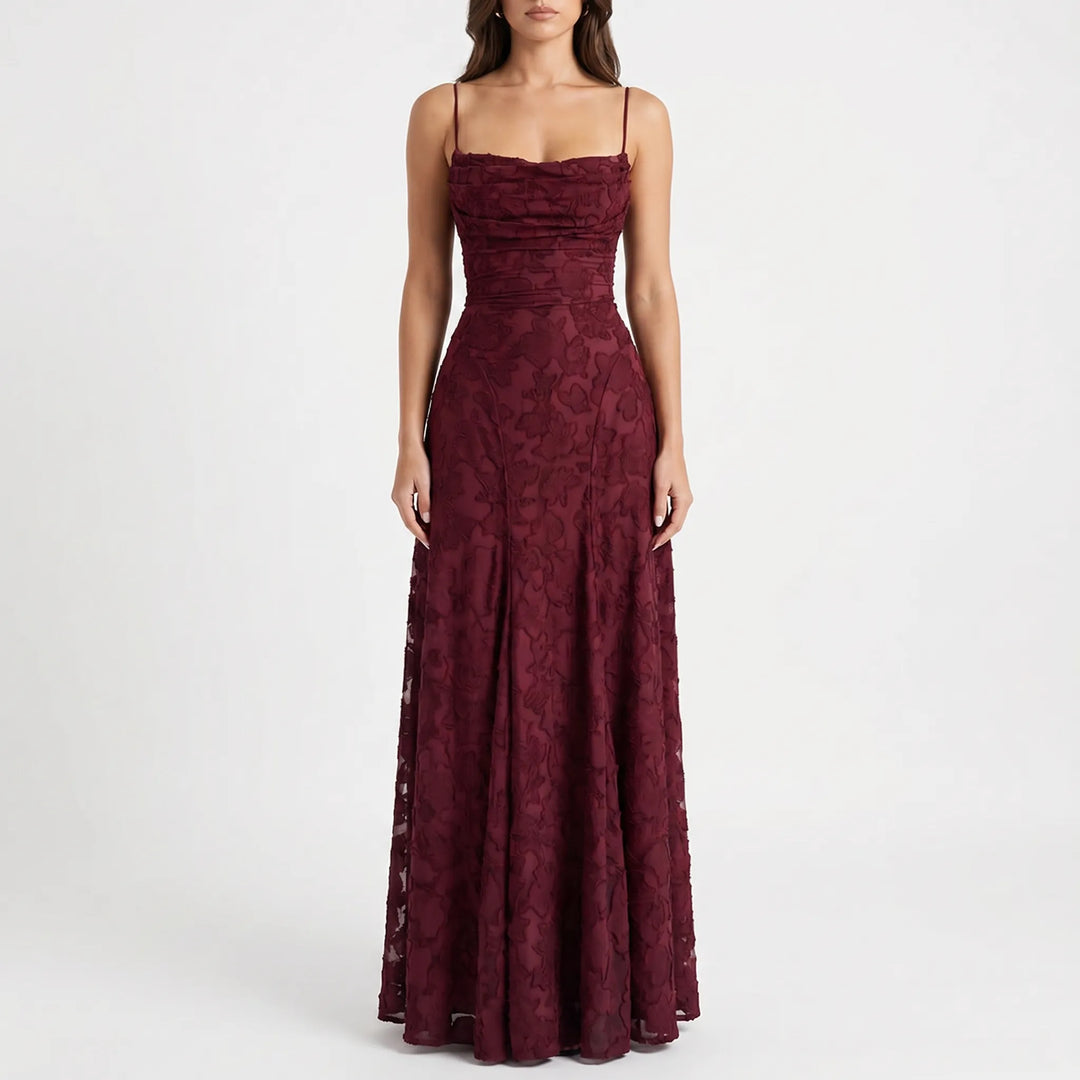 Floor-length women's formal evening gown featuring a delicate floral pattern and slender spaghetti straps.