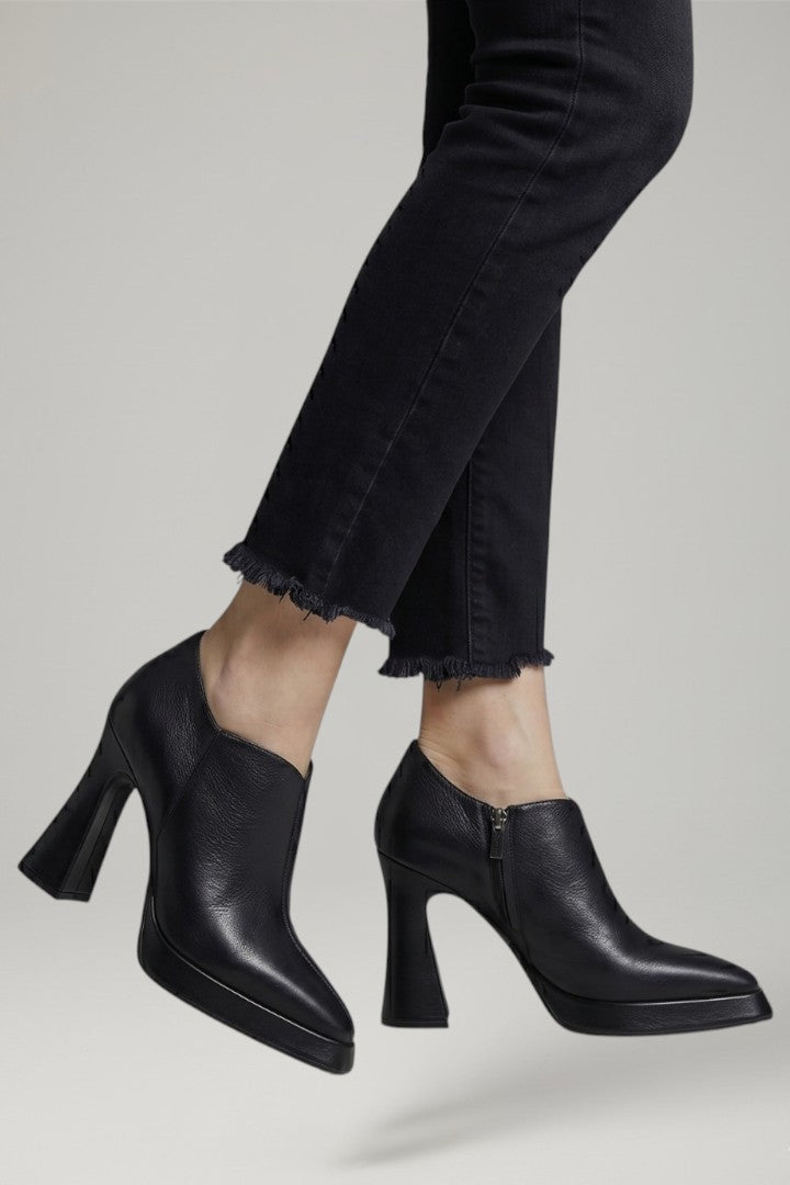 Modern women's elevated platform pumps featuring a side zipper and sturdy block heels for fashion.