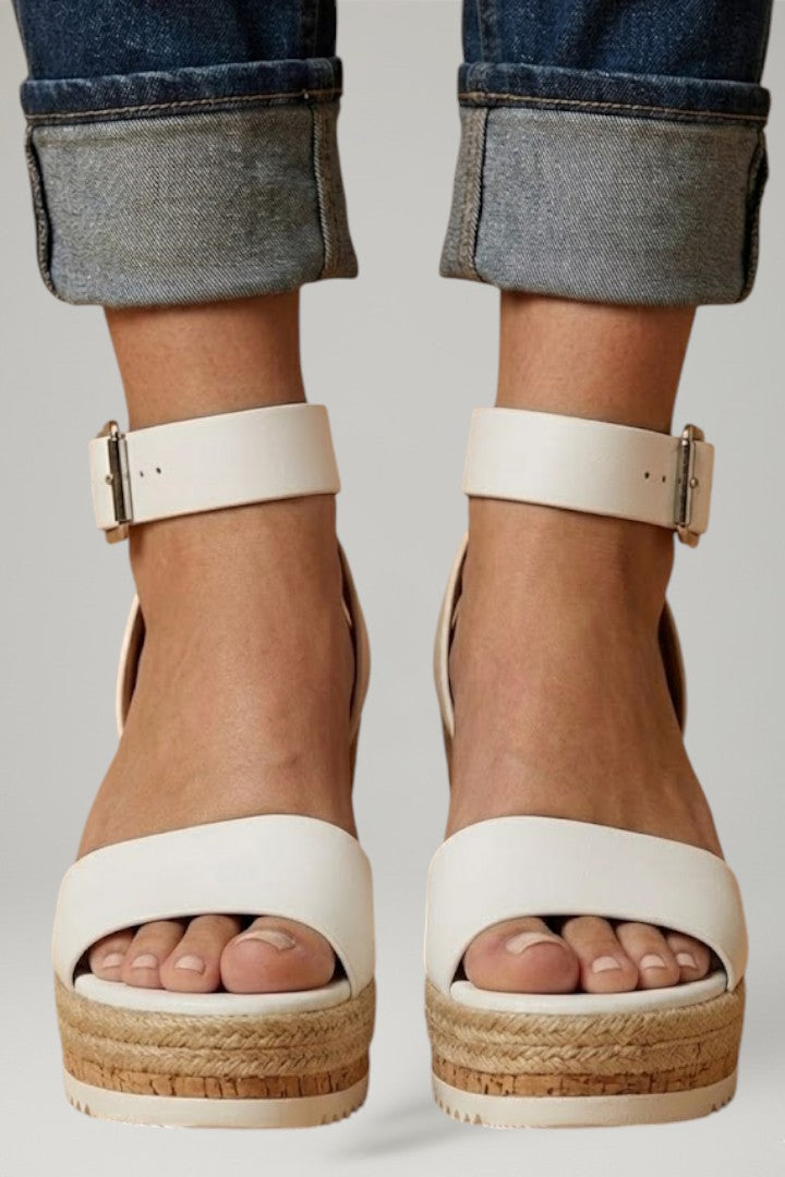 Chic women's wedge sandals with secure strap fastening, providing a comfortable and stylish open-toe option for summer.