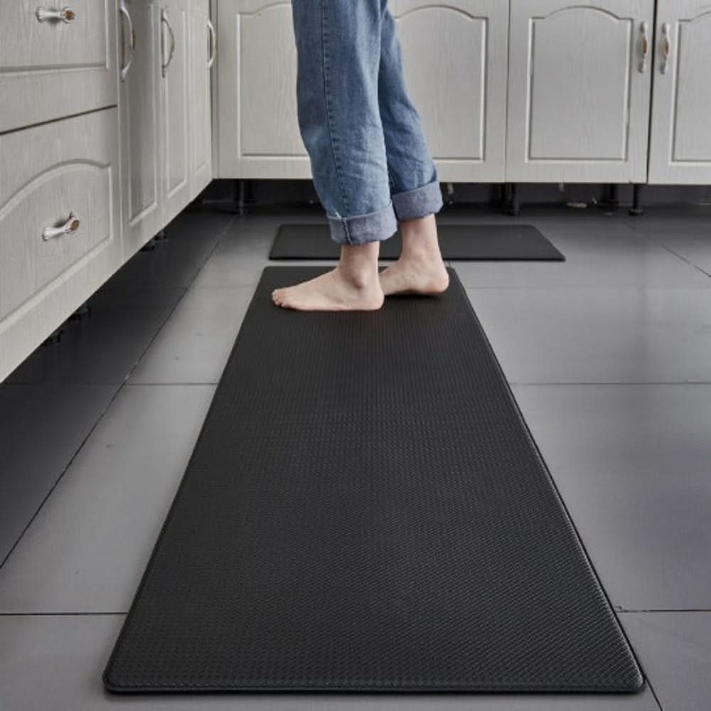 Non-slip ergonomic kitchen mat offering cushioned support & standing comfort in a modern kitchen.
