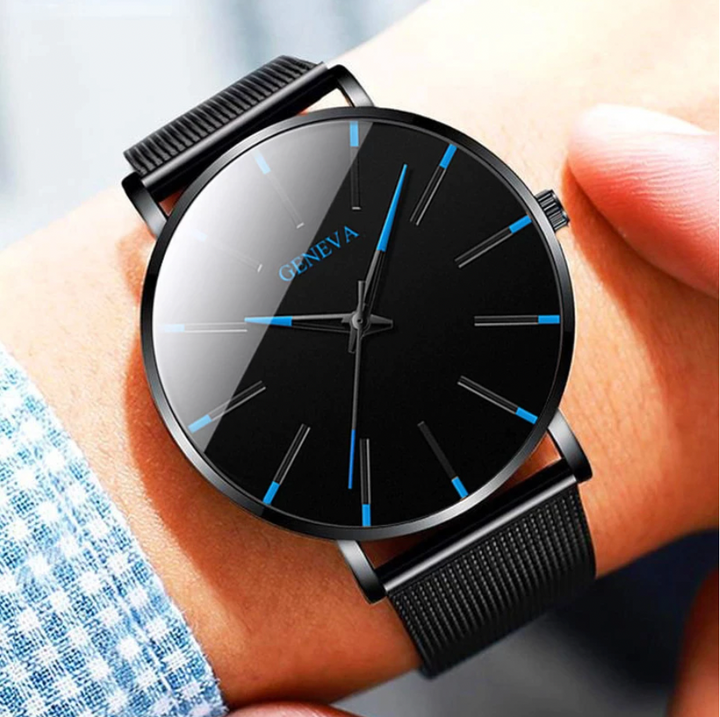 Minimalist men's watch with sophisticated blue accents and a sleek black leather strap. Modern timepiece accessory.
