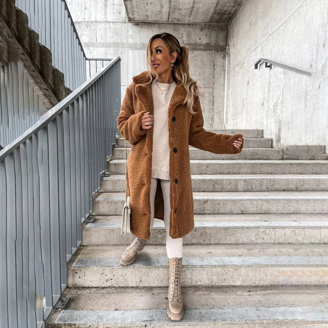 Stylish women's long teddy coat for winter. Cozy, warm fall outerwear with a fashionable oversized fit and lapels.