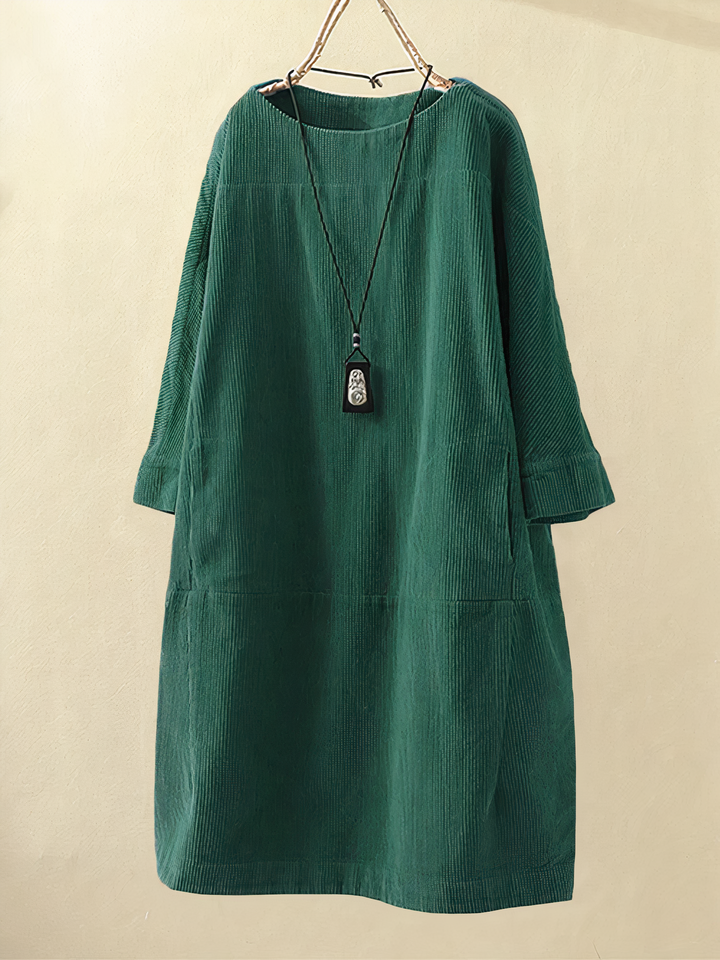 Versatile women's midi dress for everyday wear. Cozy, comfortable, features pockets, elbow sleeves, and round neck.