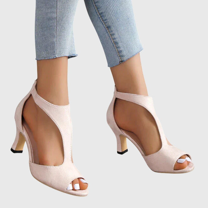 Comfortable fashion block heel sandals for women with a stylish cut out design and peep toe.