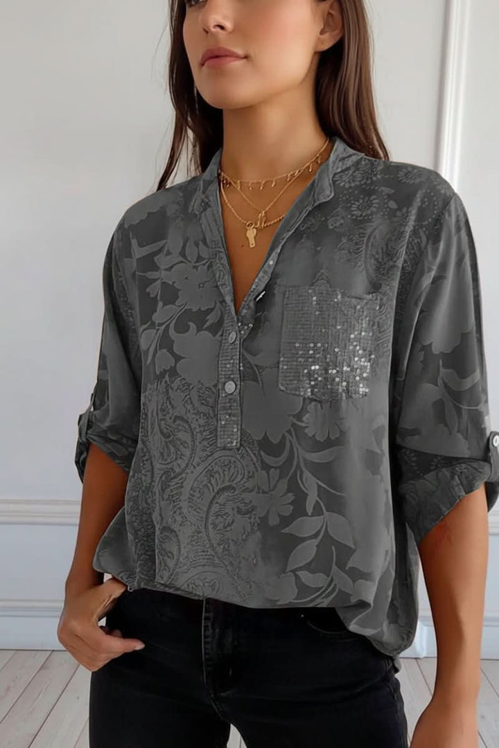 Close-up of the front pocket and print on a chic women's long sleeve blouse, perfect for summer fashion.
