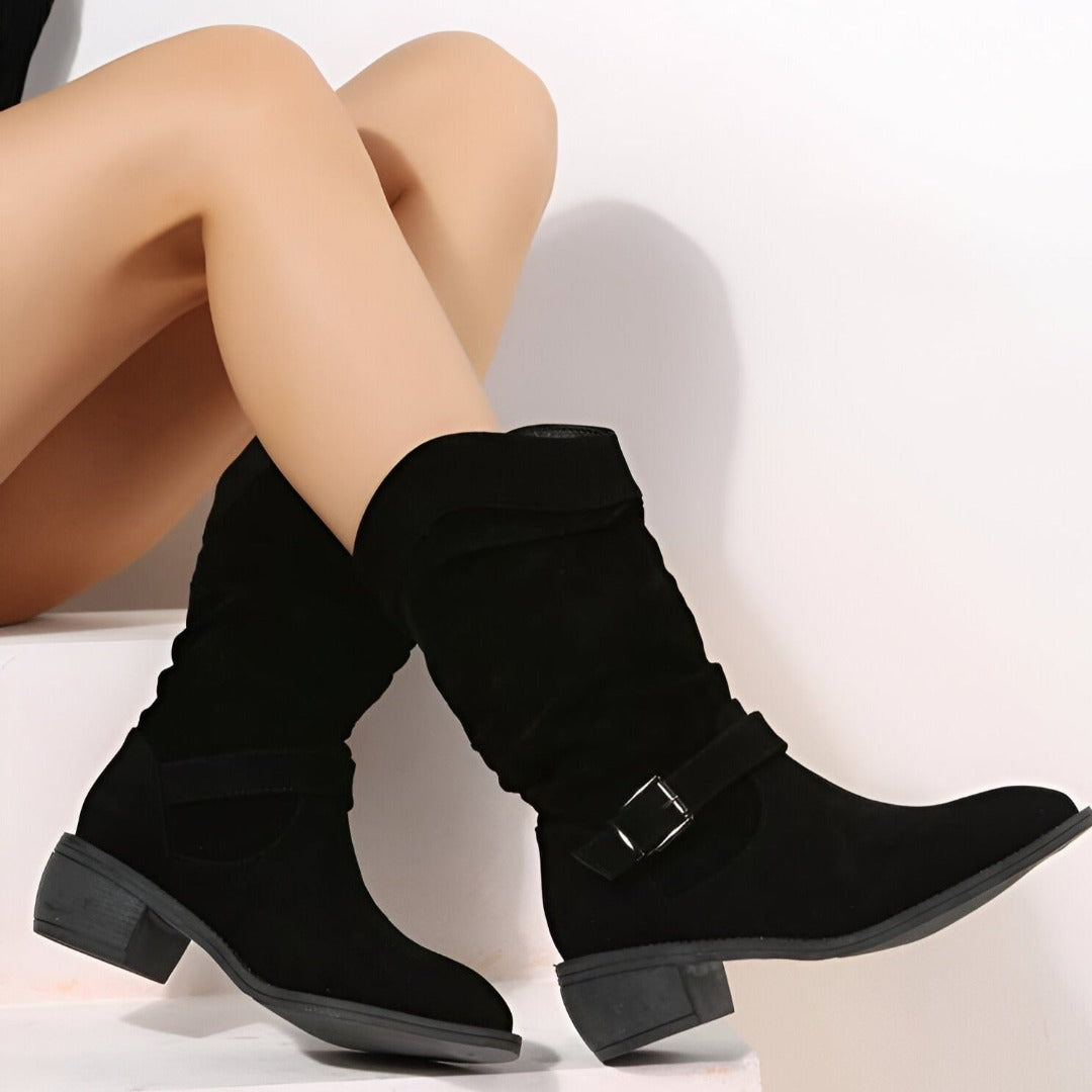 Soft-looking slouchy ankle boots for women, designed with a low heel and an elegant buckle detail.