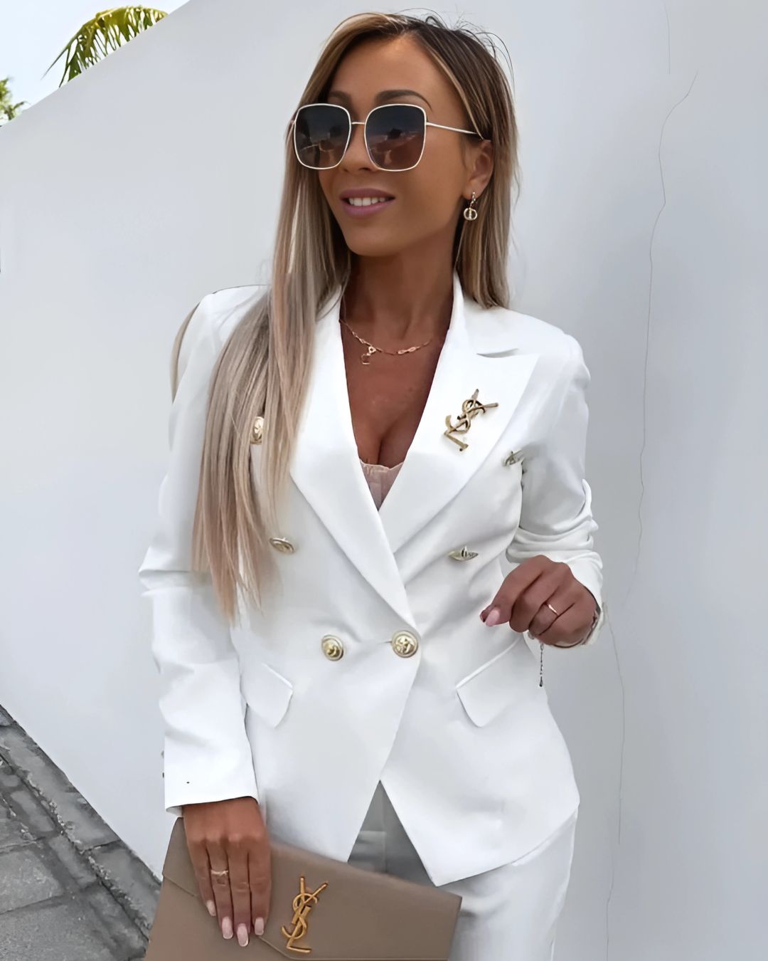 "Chic women's double-breasted suit set with tailored trousers, featuring notched lapels and metallic buttons for a sleek look