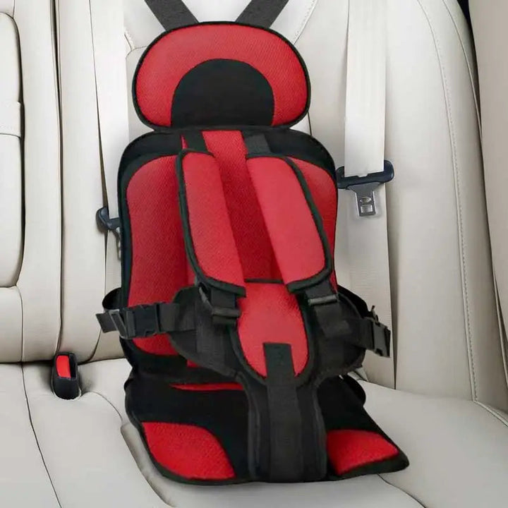 "Child safety car cushion seat in bright red with comfy padding and adjustable straps for secure, cozy travel."