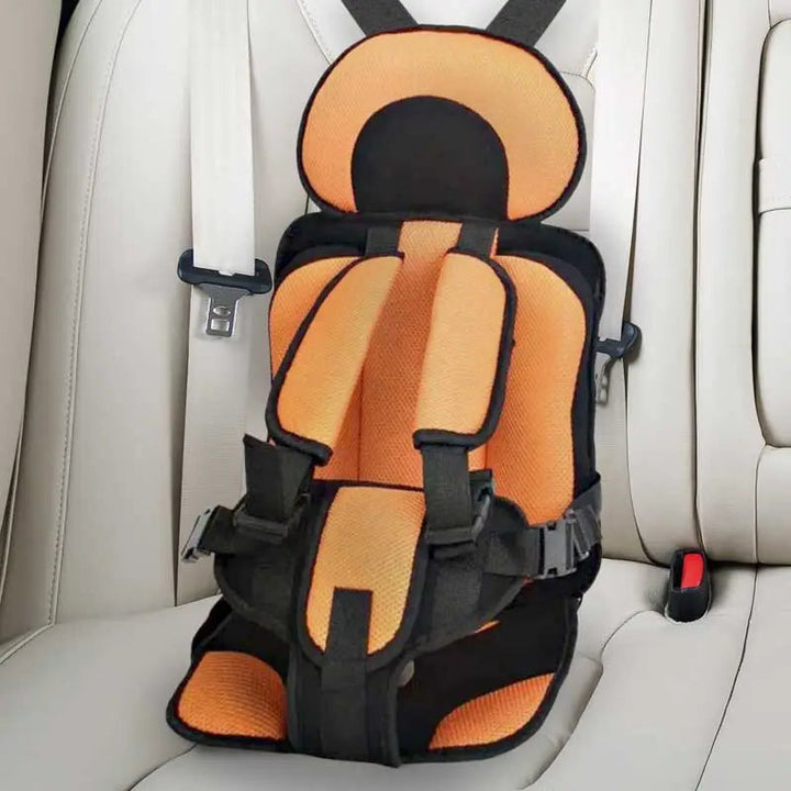"Child safety car cushion seat in bright red with comfy padding and adjustable straps for secure, cozy travel."